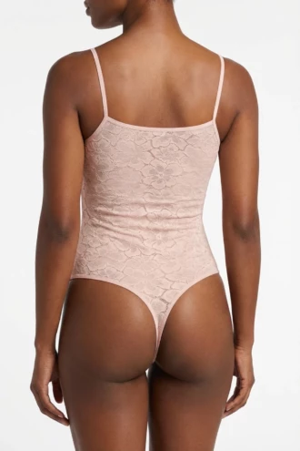 Sleeveless all-lace tank bodysuit by Tiara Galiano in dusky pink, the lace on show under an open shirt.