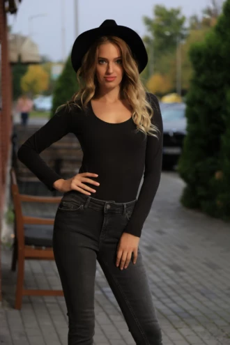 Black wool-blend bodysuit with scoop neck and long sleeves, worn alone with high-waisted trousers.