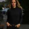 Black wool-blend bodysuit by Tiara Galiano with mock neck and long sleeves, a warm lightweight winter base.