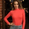 Breathable cotton bodysuit with long sleeves and hook-and-eye closure, a versatile everyday layer.
