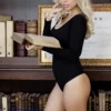 Breathable cotton bodysuit by Tiara Galiano with long sleeves and hook-and-eye gusset closure.