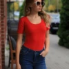 Cotton T-shirt bodysuit with scoop neck and short sleeves, the plain tee you layer under everything.