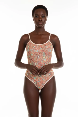 Sleeveless mesh bodysuit in an all-over paisley print with contrast cream binding at the neckline and legs.