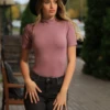 Mock-neck cotton bodysuit with hook-and-eye closure and thong cut, smooth under a blazer or on its own.