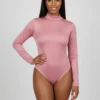 Women's pink mesh bodysuit with a mock neckline, long sleeves and a thong cut in fine semi-sheer mesh.