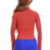 Polo-style lace-and-mesh bodysuit with long sleeves and thong back, worn on its own with dark denim.