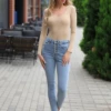 Scoop-neck cotton bodysuit with thong bottom and a relaxed shirt-style line under fitted clothing.
