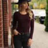 Scoop-neck long-sleeve cotton bodysuit that sits close without restricting, relaxed shirt-style cut.