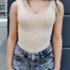 Sleeveless cotton tank bodysuit with hook-and-eye closure and thong cut, smooth under knitwear or alone.