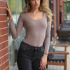 Tiara Galiano cotton bodysuit with scoop neck and long sleeves, relaxed and breathable to layer.