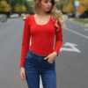 Versatile long-sleeve cotton bodysuit with thong bottom and relaxed shirt-style cut for daily wear.