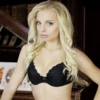 Black lace bra with molded cups in floral lace over a microfiber band, finished with a scalloped neckline.