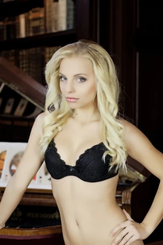 Black lace bra with molded cups in floral lace over a microfiber band, finished with a scalloped neckline.