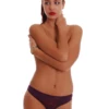 Breathable cotton bikini briefs with an opaque seat and a lace triangle opening one side.