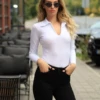 Long-sleeve cotton blouse bodysuit by Tiara Galiano, a polished base layer under a blazer or with denim.