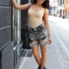 Sleeveless cotton-blend bodysuit with scoop neck and racerback, breathable sporty layer for women.
