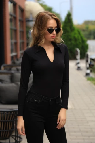 Women's cotton-blend bodysuit with thong cut and full-length sleeves, a neat polished base layer.