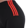 Close-up of black cotton leggings waistband with three red stripes, showing fabric texture detail