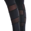 Close-up of black microfiber leggings showing the sheer mesh panels at the calf, fabric detail