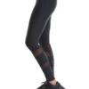 Black high-waisted microfiber leggings with mesh side inserts, side view of the slim athletic line