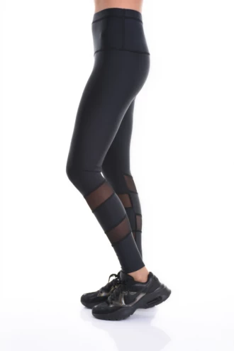 Black high-waisted microfiber leggings with mesh side inserts, side view of the slim athletic line