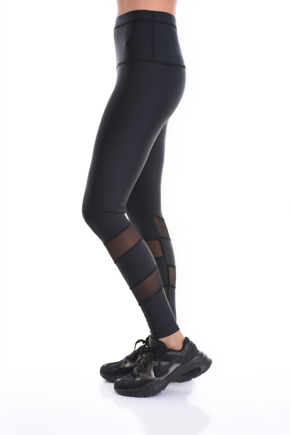 Black high-waisted microfiber leggings with mesh side inserts, side view of the slim athletic line
