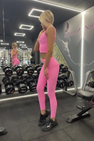 Pink high-waisted microfiber leggings, side view highlighting the dense smooth stretch fabric