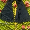Black halter bikini top in quick-drying polyamide with a lace-up front detail, light and easy for the beach.