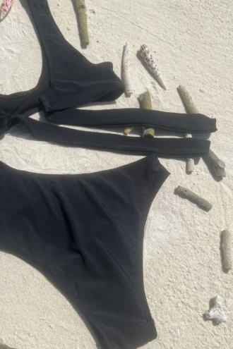 Modern black one-piece swimsuit with subtle waist cutout in light stretchy quick-drying fabric.