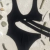 Black scoop-front swimsuit with Brazilian back coverage in smooth light polyamide swim fabric.
