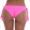 Solid candy pink cheeky Brazilian swim bottom in stretchy polyamide, adjustable bows for a custom fit.