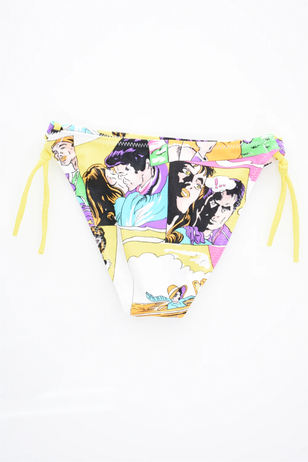 Yellow comic-book print girls' swim bottom with adjustable side ties, light quick-drying fabric for the pool, beach or garden.