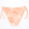 Washed-peach girls' swim bottom with adjustable side ties, softly stretchy quick-drying fabric for warm days outdoors.