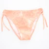 Girls' tie-side bikini bottom by Tiara Galiano in a soft washed-peach with a mottled look and matching side ties, quick-drying polyamide.