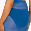Soft light blue mesh sarong wrap for women, weightless one-size beach cover-up that knots low on the hips by the pool.