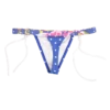Mixed-print swim thong with a pink-and-yellow floral waistband over a dotted body, low minimal cut with white ties.