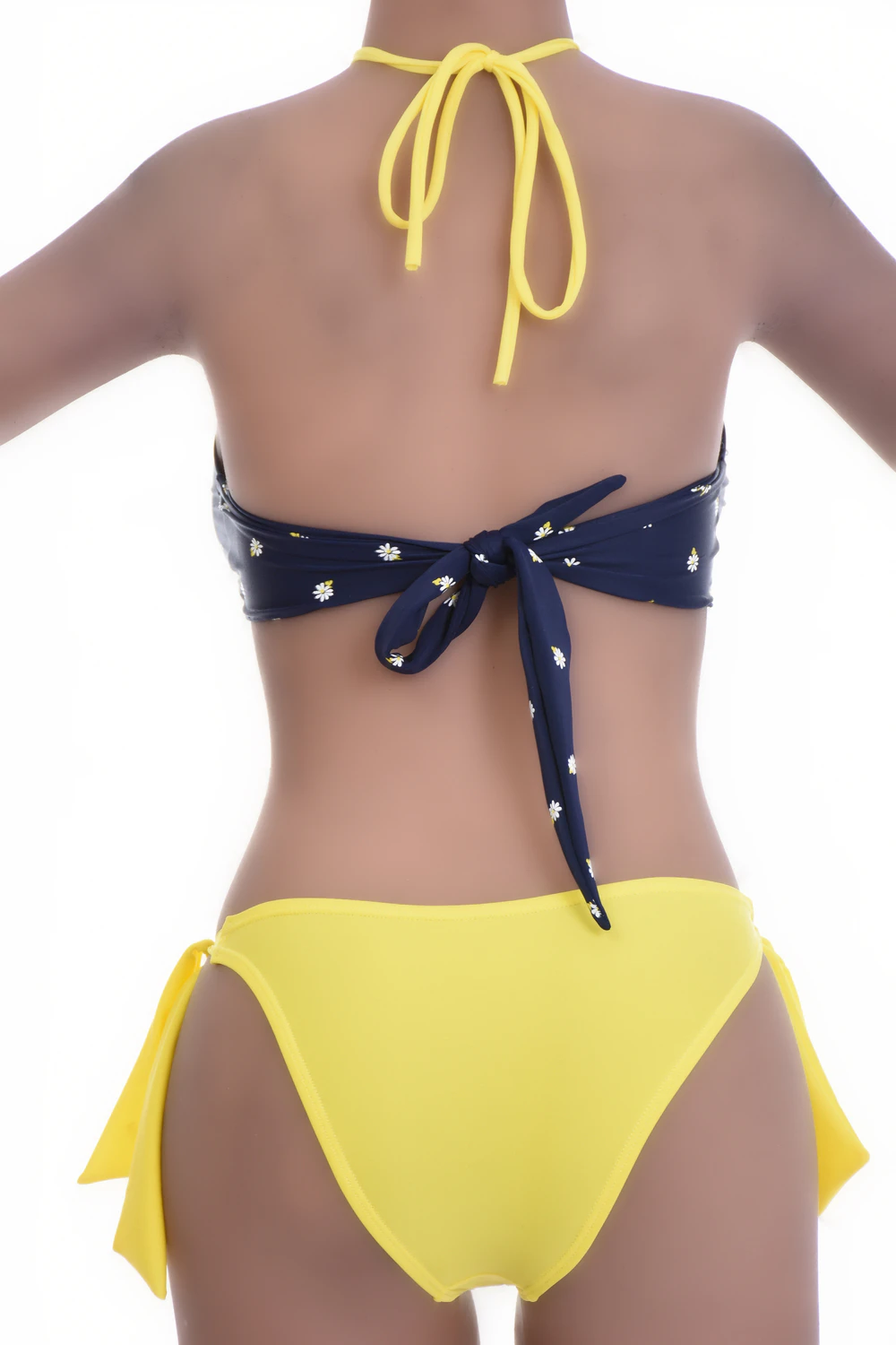 Navy dot-print bandeau bikini top worn as halter or strapless with a tie back for women.
