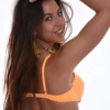Orange underwire bikini top with molded push-up cups and thin adjustable straps that lift and round the bust.