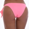Pink bikini bottom with wide bow side ties, a moderate front and a cheeky back that knots at each hip.