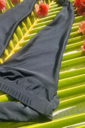 Triangle bikini top in polyamide with light unpadded cups and a waist band that wraps and ties to set the fit.