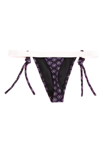 Purple geometric-print string thong bikini bottom with medallion motifs over black and a contrast cream waistband.