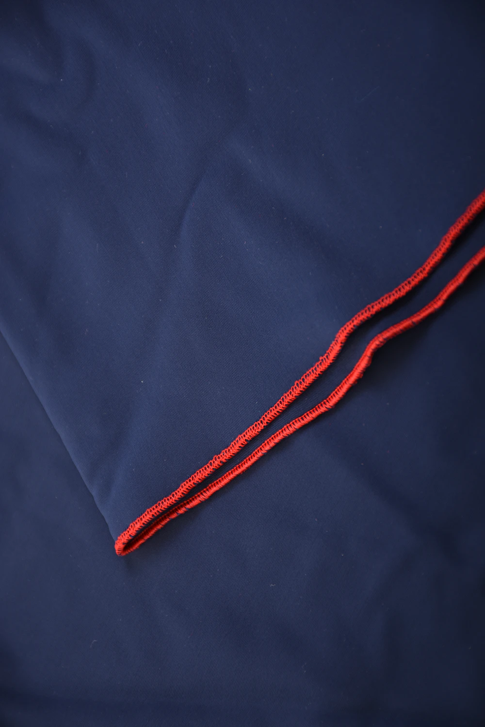 Dark blue microfiber short sarong by Tiara Galiano, a soft rectangular wrap that ties over a swimsuit at the hips.