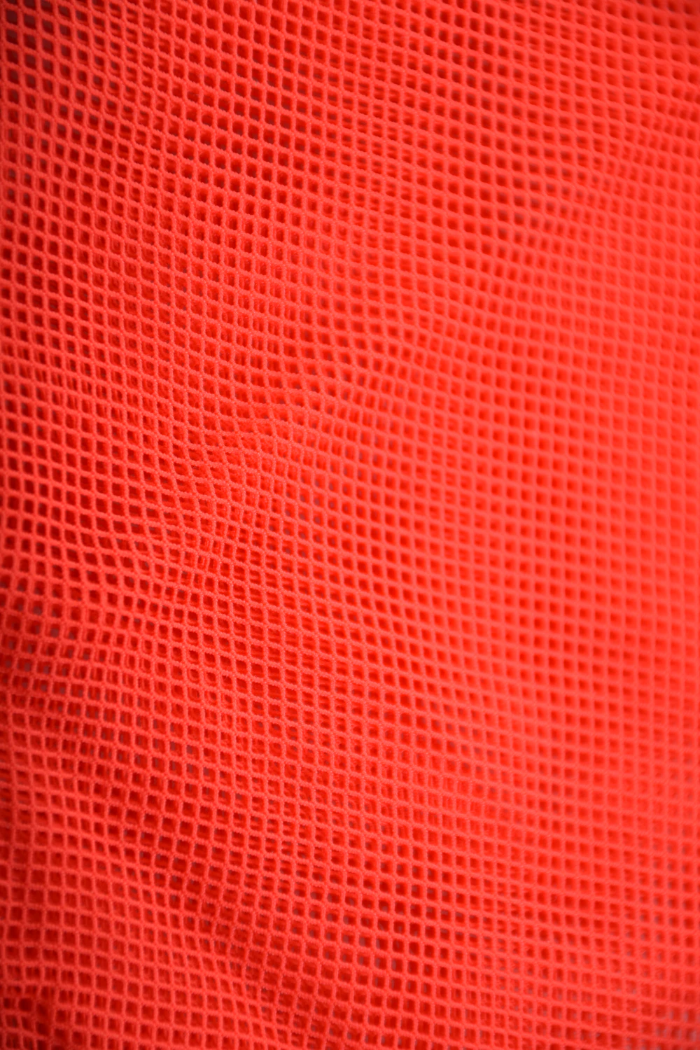 Red sheer mesh short sarong by Tiara Galiano, a lightweight rectangular wrap that ties over a swimsuit at the hips.