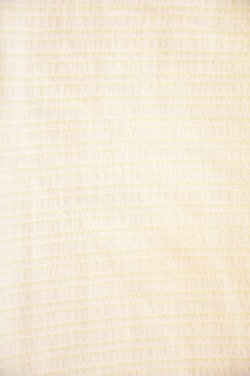 Yellow sheer mesh short sarong by Tiara Galiano, a lightweight rectangular wrap that ties over a swimsuit at the hips.